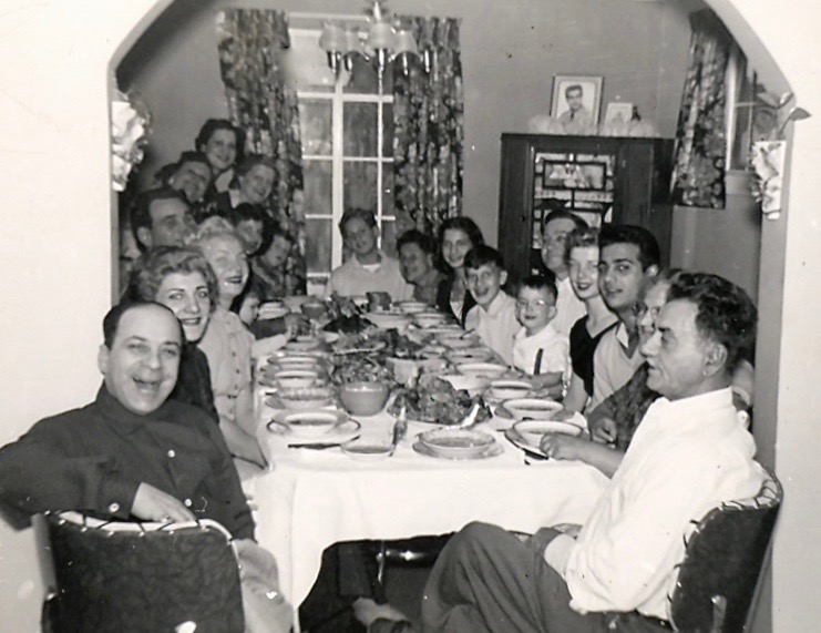 Italian American family eating dinner around the dining room table in Detroit 1050s